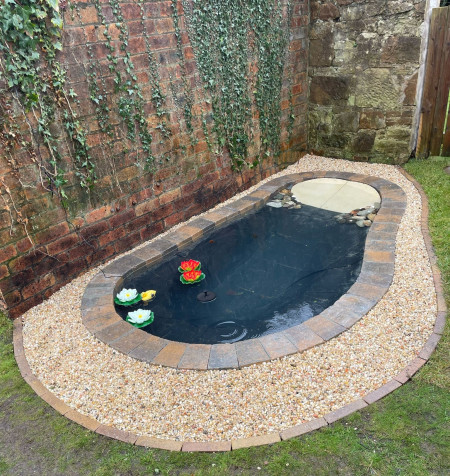 Lanscaped pond with gravel surround
